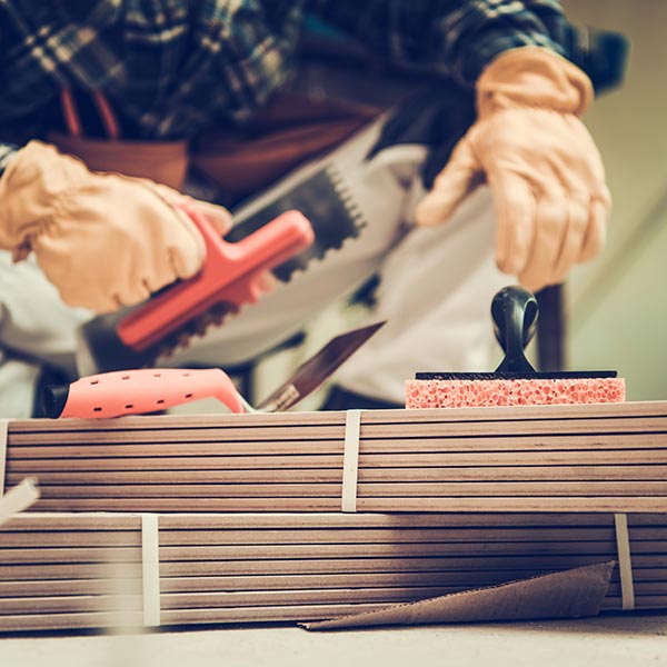 Tiler with his tools ready to install ceramic tiles